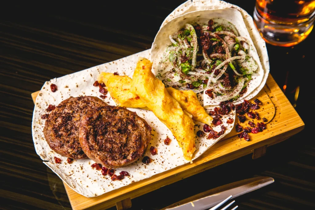 Pljeskavica Balkan burger with traditional sides